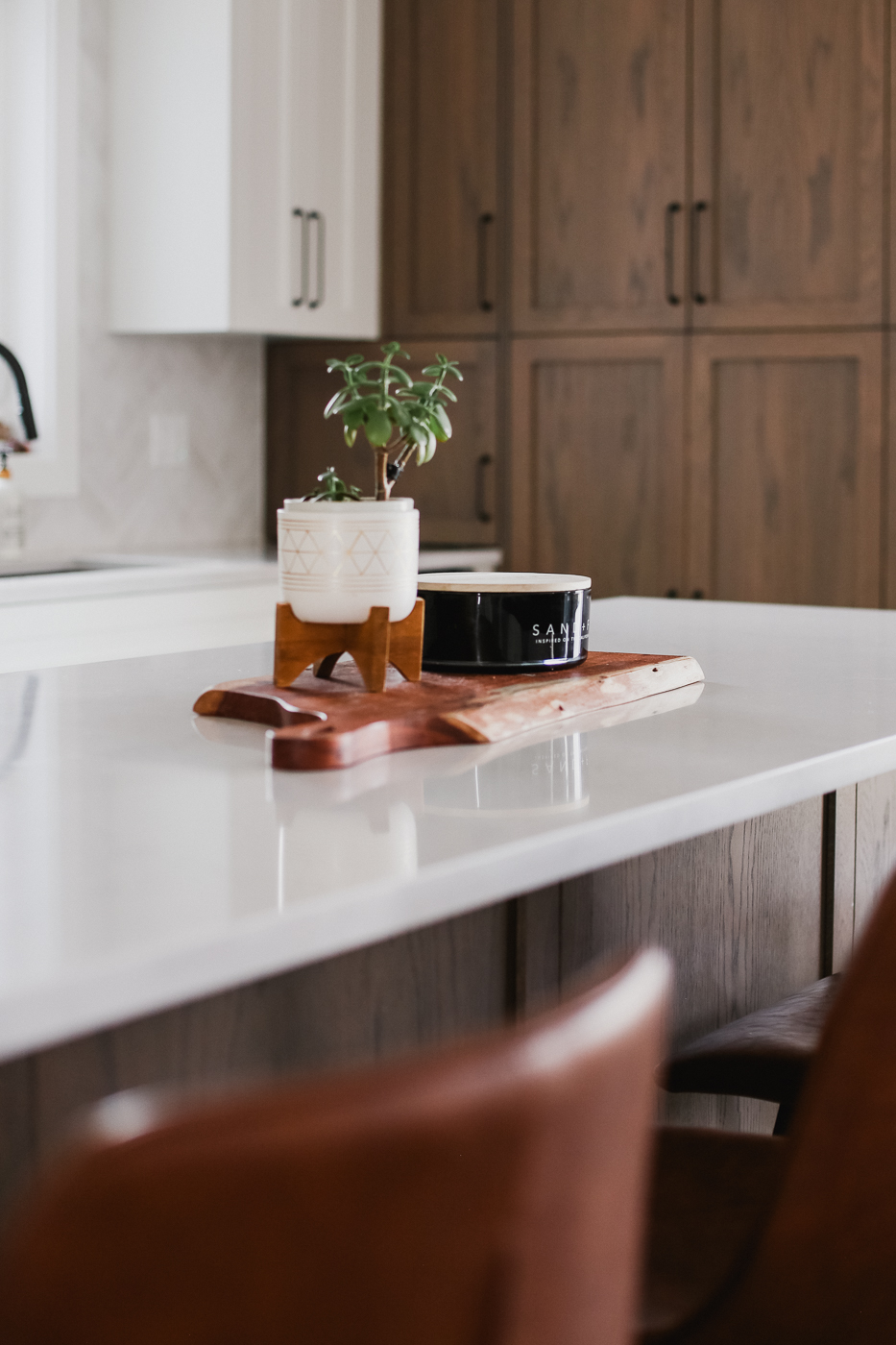 Decorative tray with candle and plant on white kitchen island. in Calgary | Kavaleer Renovations Decorative tray with candle and plant on white kitchen island. in Calgary | Kavaleer Renovations